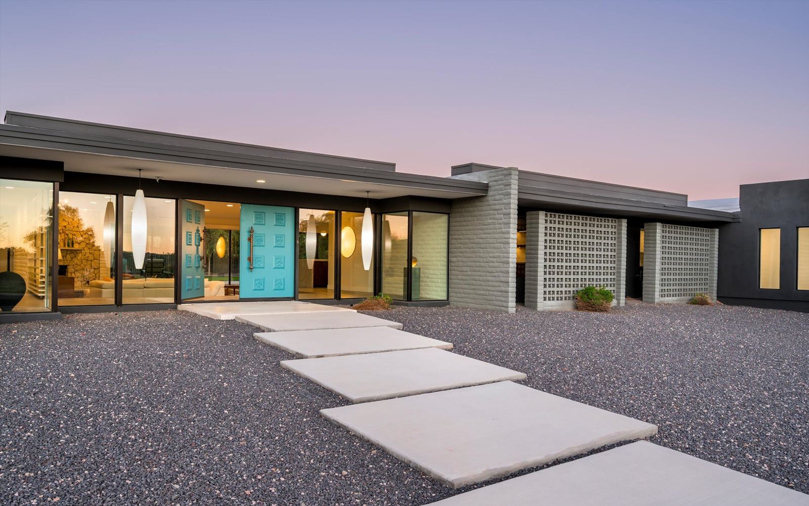 Mid-century modern home with breeze-block screens and turquoise doors