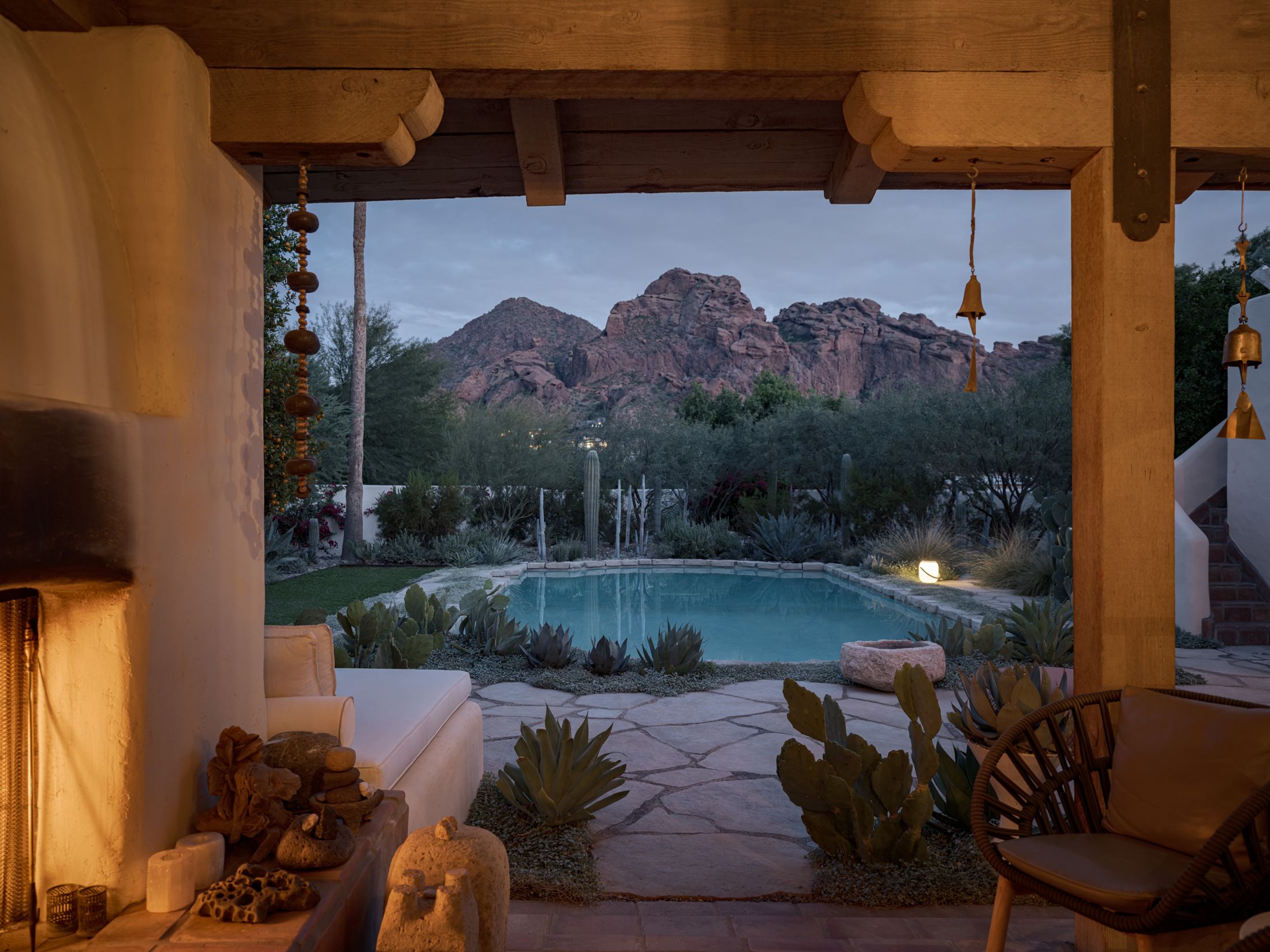 Covered patio and pool framing Camelback Mountain at dusk in Paradise Valley